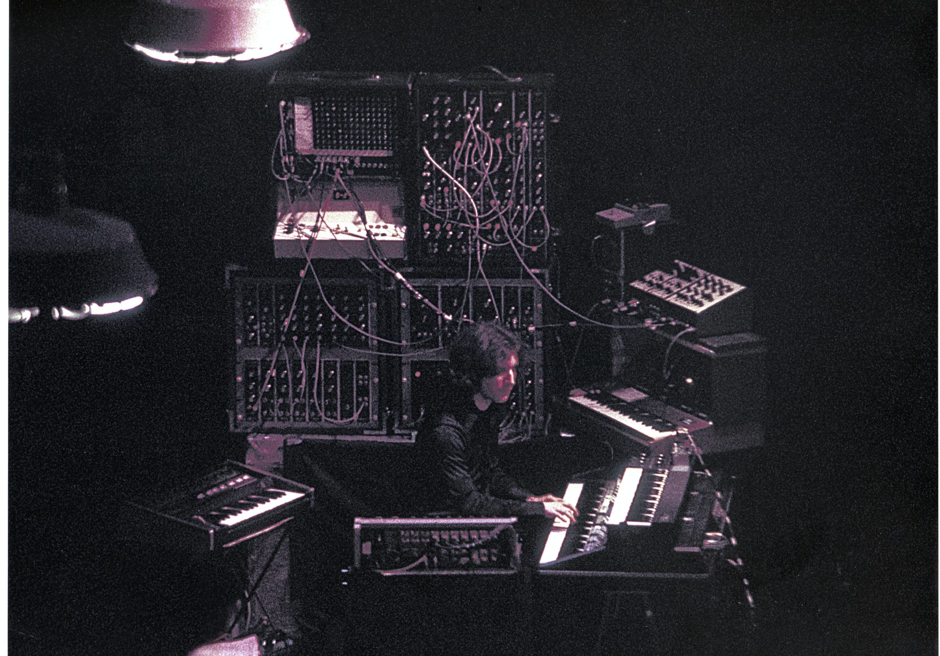 Music Producer Sitting in a Studio in front of a Computer and Console 